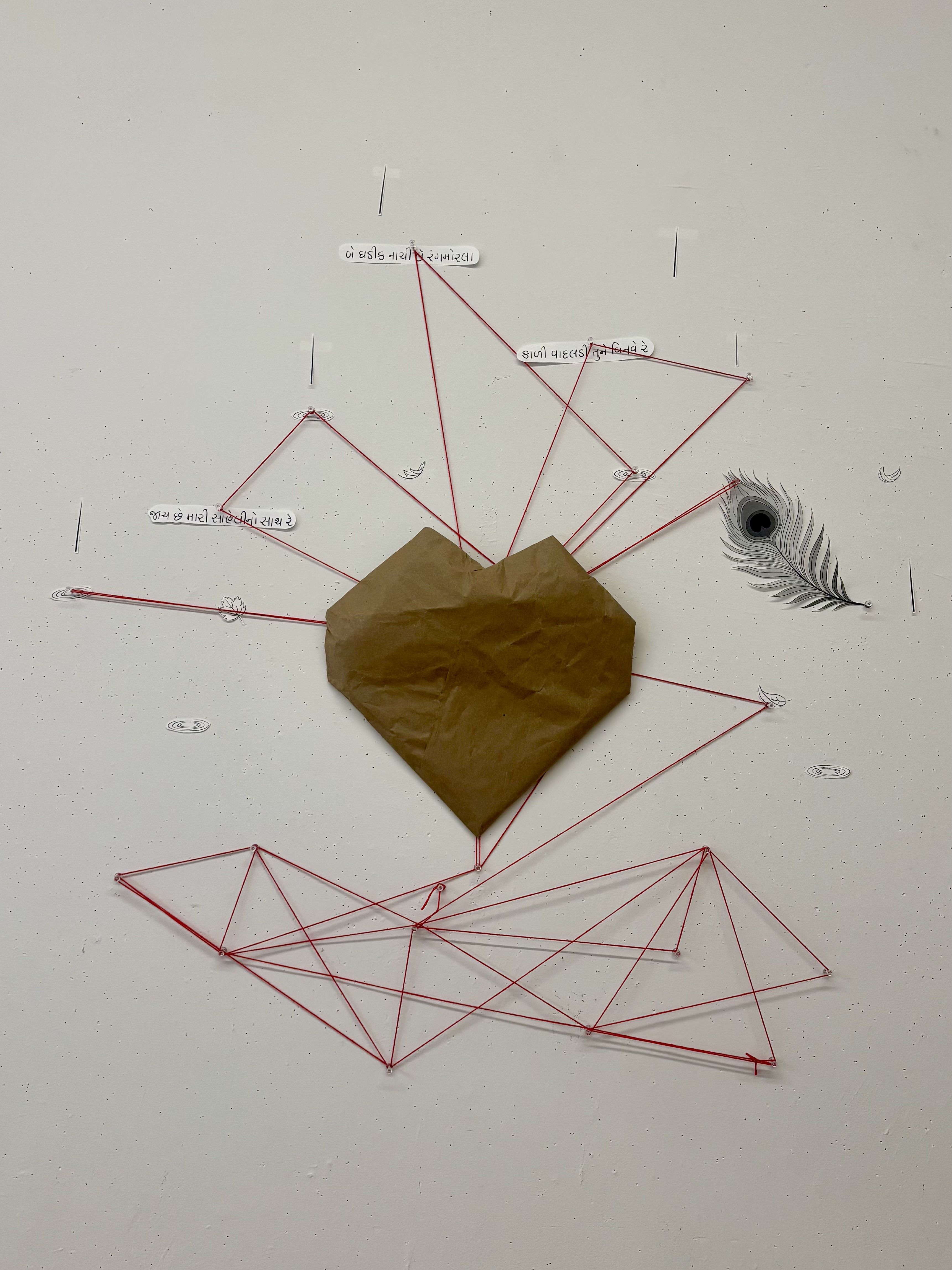 Installation: Exploration of connection, fragility, and transformation. At the center of the is a cardboard heart, a symbol of life and pulse, through which red thread flows. Below the heart the thread forms tangled roots that carry the weight of chaos and confusion. As it passes upward through the heart, the thread begins to unravel and branch out into clarity, reaching toward fragments that represent moments from the poem and from nature. These elements become extensions of the heart’s rhythm, each connected by the same red thread. The work reflects on how everything fragile is held together by unseen forces, and how clarity can emerge out of disorder through interconnection.
